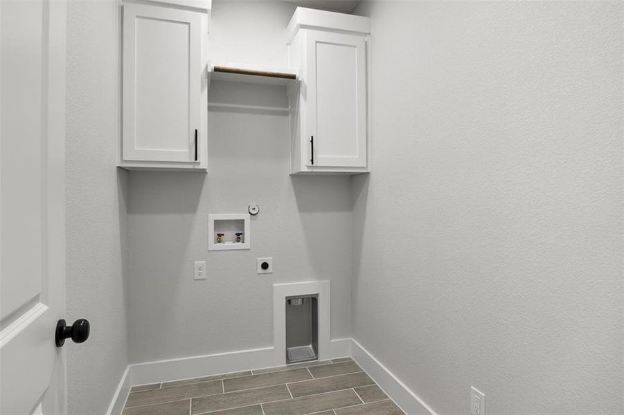 Laundry room featuring hookup for a washing machine, cabinets, gas dryer hookup, and electric dryer hookup