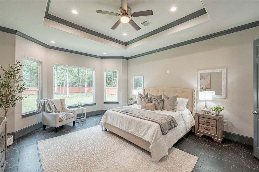 Primary bedroom with sitting area has a great view of the back yard