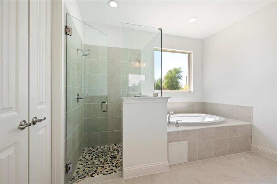 Bathroom with plus walk in shower and tile patterned flooring