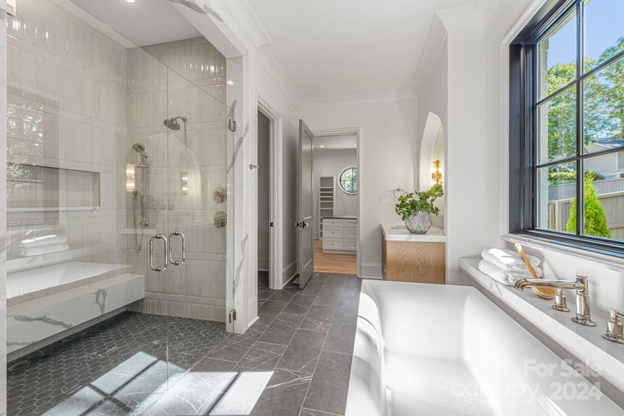 Spa-like primary bath with large shower and soaking tub