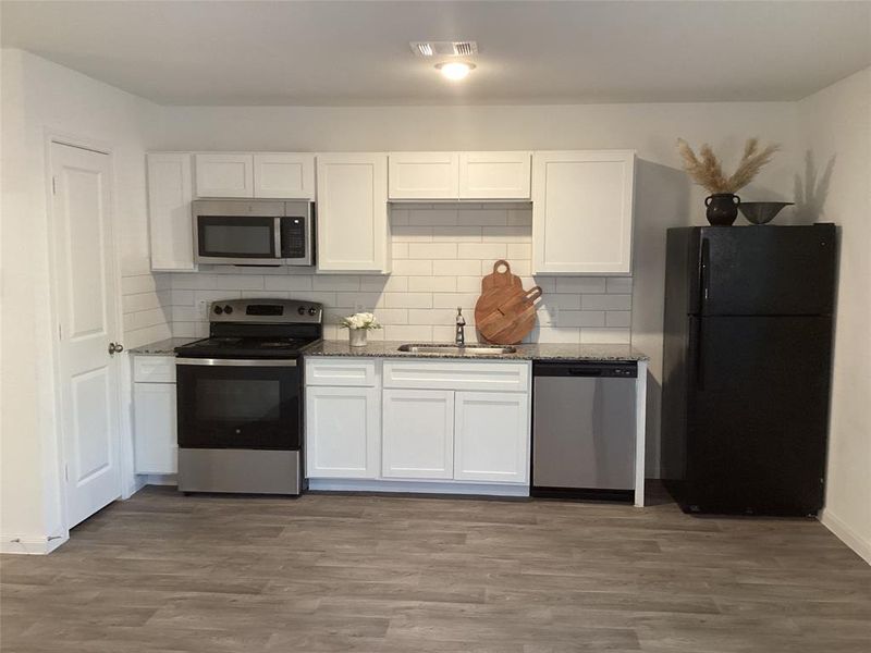 Modern Galley Kitchen with Sleek Appliances including refrigerator