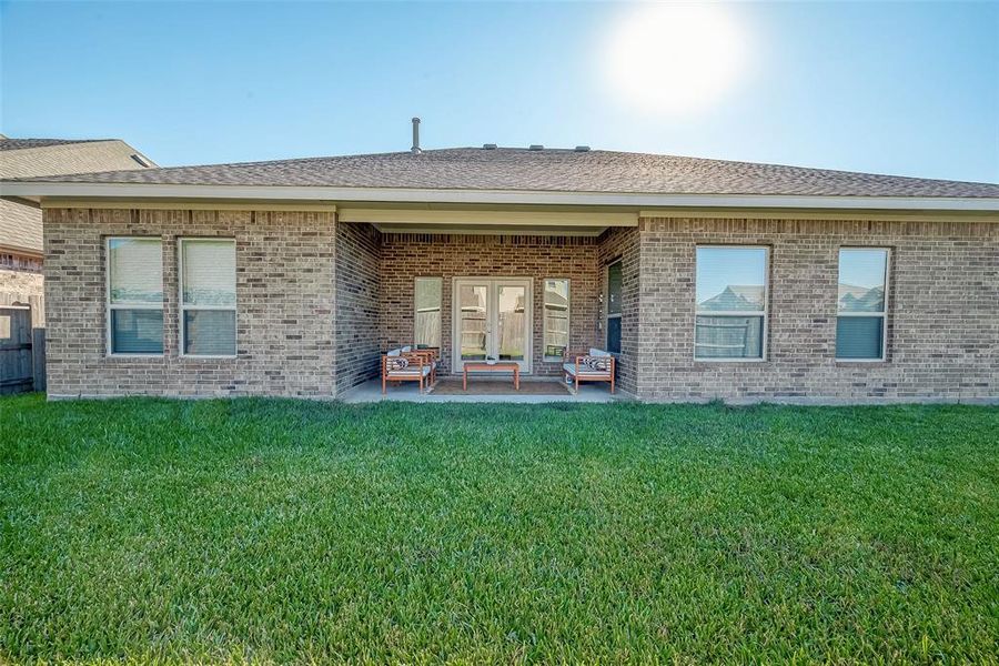 Step into the backyard oasis, with a covered patio, creating aninviting outdoor retreat.