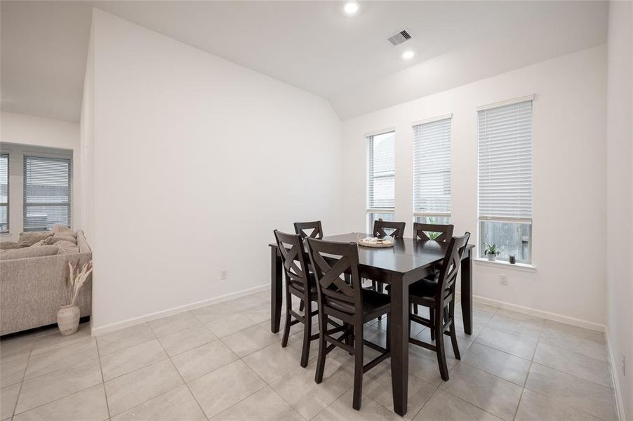 Dining room with ample natural light, perfect for formal gatherings and family dinners