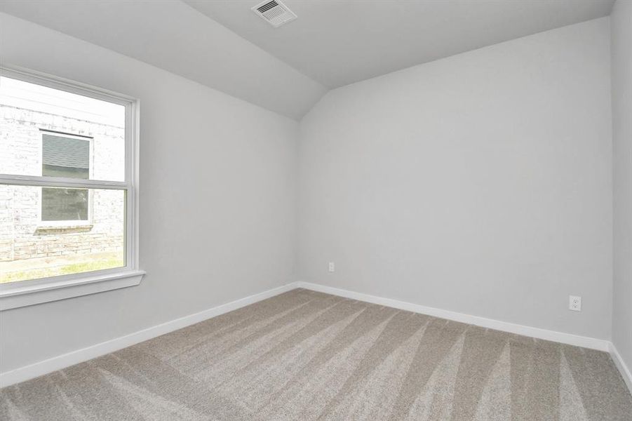 Generously sized secondary bedrooms featuring spacious closets, soft and inviting carpeting underfoot, large windows allowing plenty of natural light. Sample photo of completed home. As-built color and selections may vary.