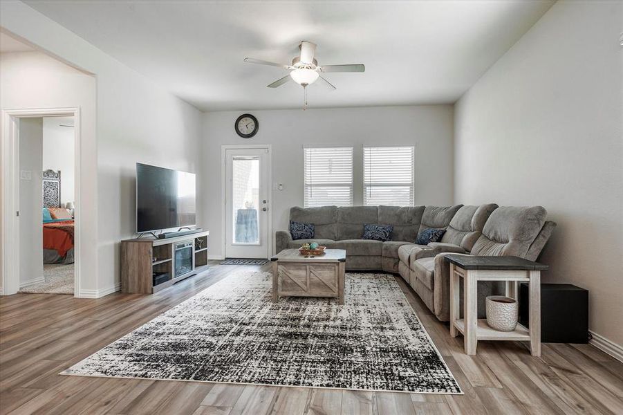 Living room featuring hardwood / wood-style flooring and ceiling fan