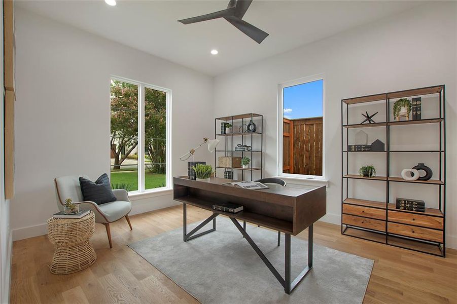 Office space featuring a wealth of natural light, light hardwood / wood-style flooring, and ceiling fan