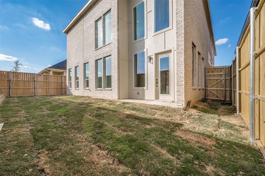 Back of house featuring a lawn