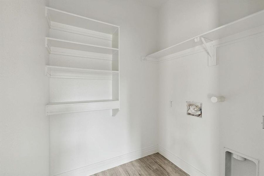 Laundry room featuring washer hookup and light hardwood / wood-style floors