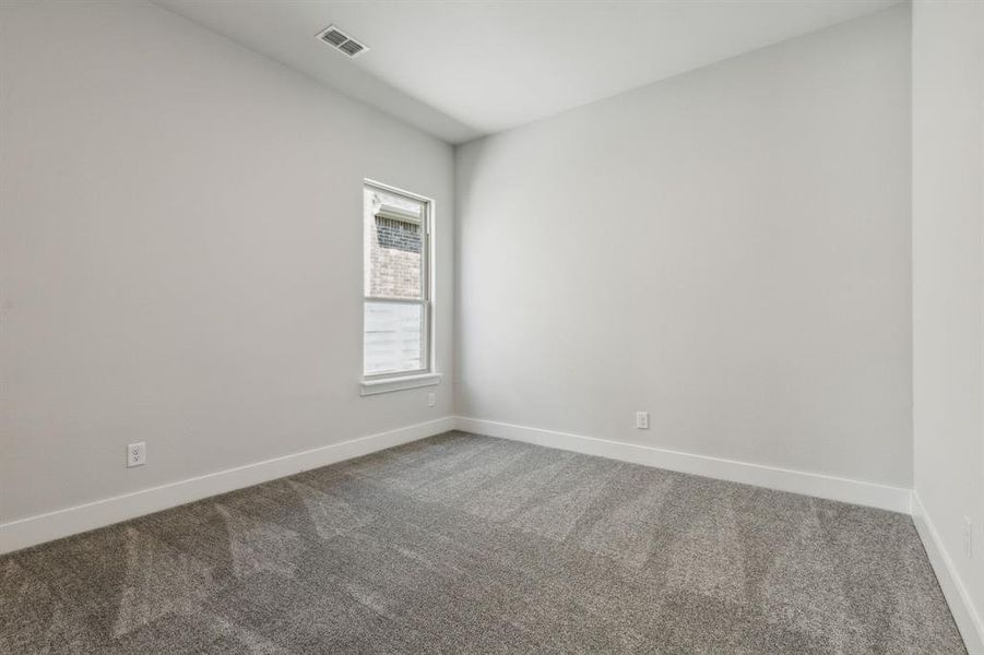 View of carpeted spare room