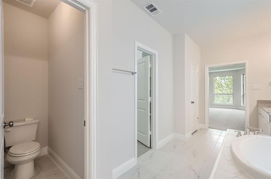 Bathroom with vanity, tile patterned flooring, and toilet