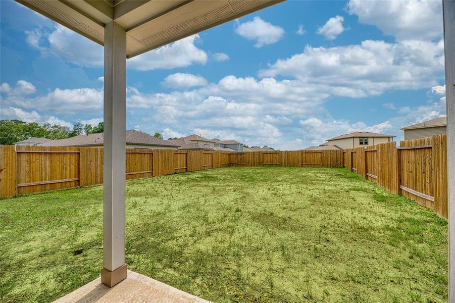 Step outside onto the covered patio that overlooks the backyard, offering a blank canvas for creating your idealoutdoor paradise. There is ample space for pets or children to play safely within the confines of the fenced-in yard, ensuring both security and peace of mind.