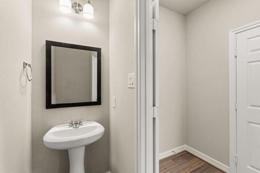 This charming home features a beautifully appointed half bath adjacent to the family room, perfect for welcoming guests and adding convenience to your daily life.