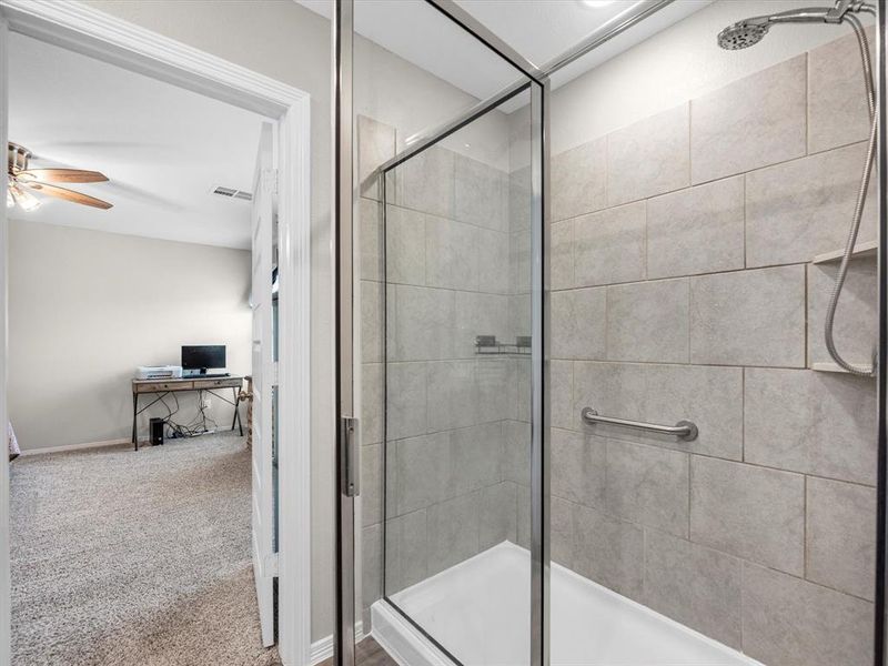 This additional view of your primary bathroom features the large walk-in shower.