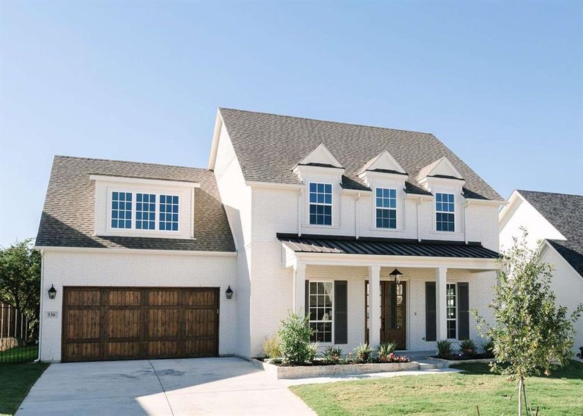 Modern inspired farmhouse with a front yard and a garage