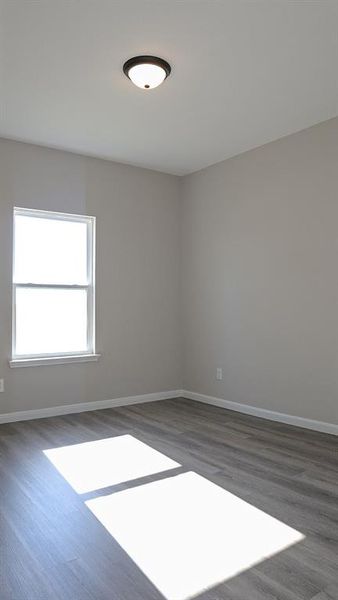 Empty room with dark hardwood / wood-style floors