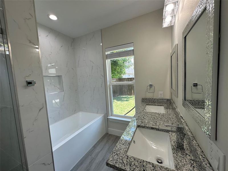 Master Bathroom with wood-type tile flooring and dual vanity
