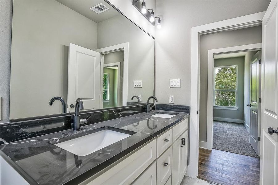 Bathroom with wood-type flooring and double sink vanity