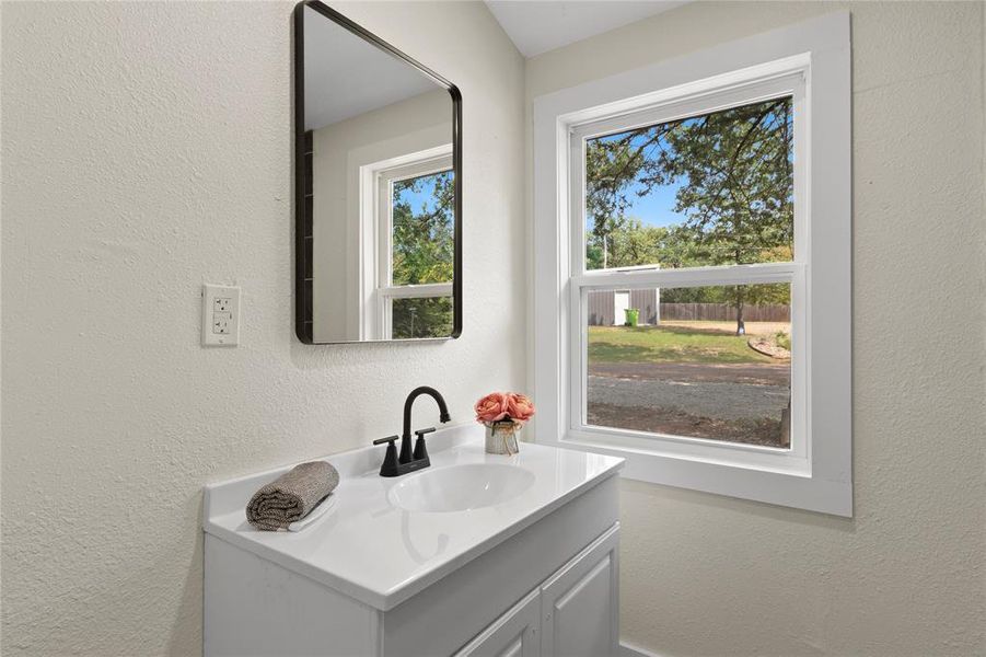 Bathroom with a wealth of natural light and vanity