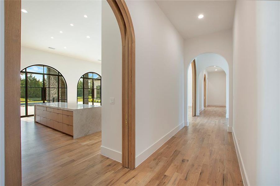 Corridor with light hardwood / wood-style flooring