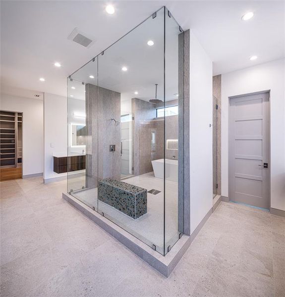 This lavish primary bathroom is certain to impress