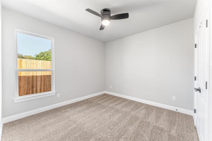 Spare room featuring ceiling fan and carpet flooring