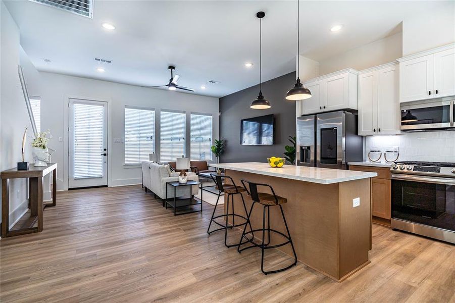 Another view of the kitchen and the living room from the dining