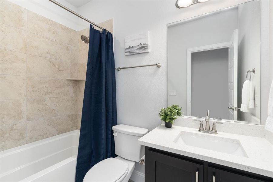 Full bathroom with vanity, toilet, and shower / tub combo with curtain