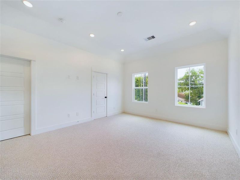 Elegant Primary Bedroom located on the 2nd floor. The high ceilings, with recessed lighting, are prewired and blocked for ceiling fans (not included). Model home photos -