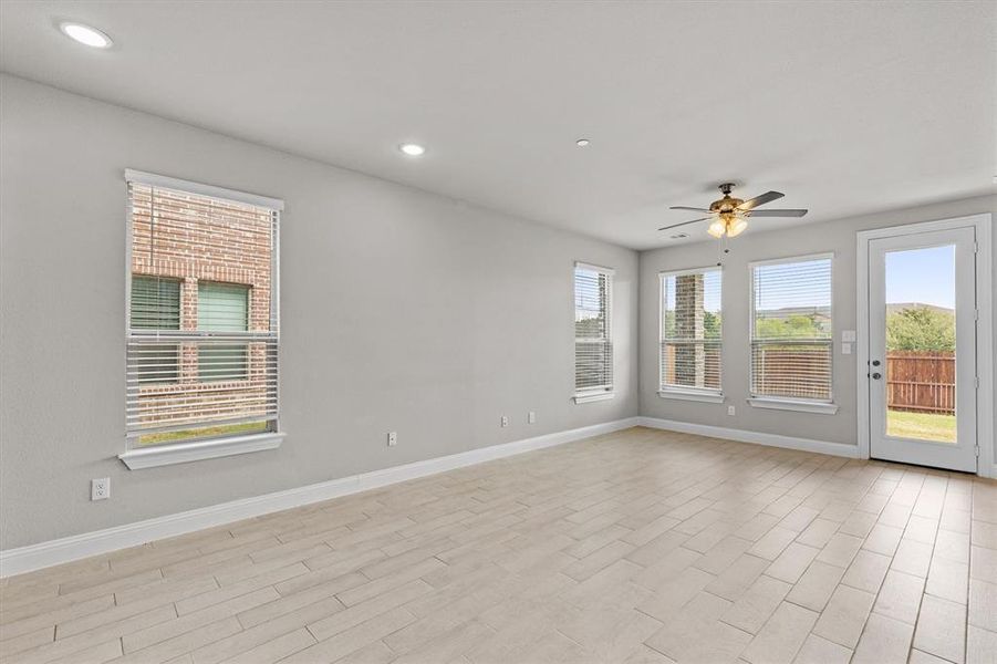 Unfurnished room with a healthy amount of sunlight, light hardwood / wood-style flooring, and ceiling fan