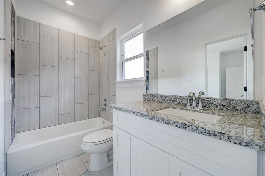Please visit 6410 Leopold Star Lane to see the builder's standard finishes. A well-sized jack-and-jill bathroom joins the secondary bedrooms. Granite tops are complimented by chrome plumbing fixtures.