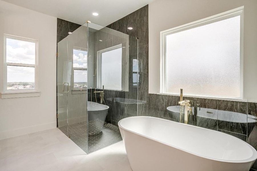 Bathroom featuring tile patterned flooring, tile walls, and plus walk in shower