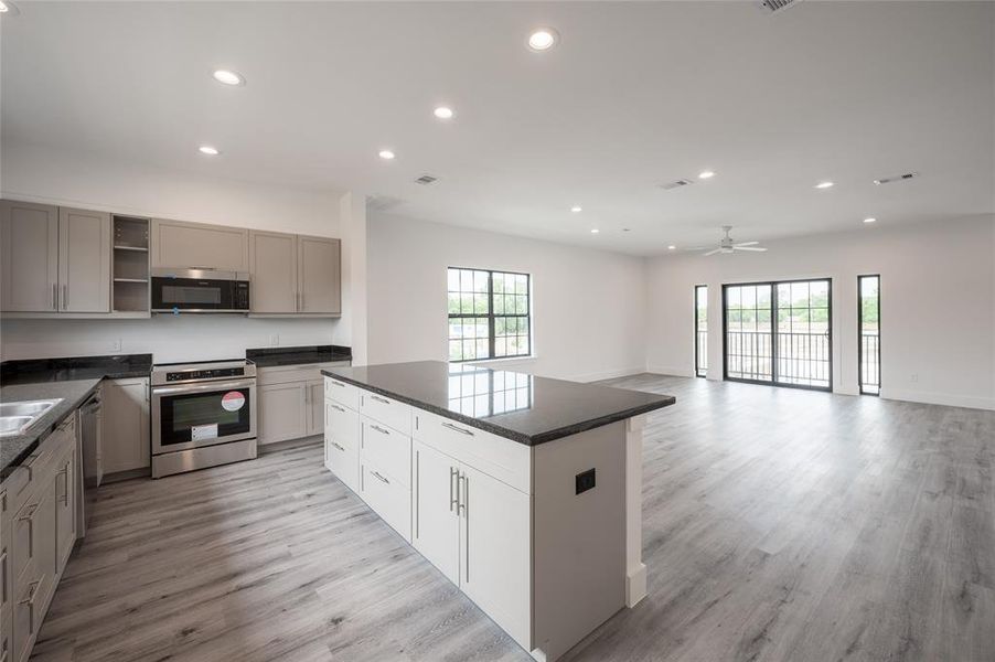 Spacious, modern open-plan kitchen and living area with ample natural light.