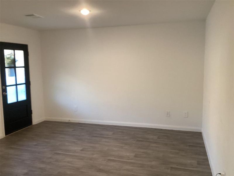 Inviting Living Space: Modern, open-concept living room with sleek LVT hardwood like floors and ample natural light, perfect for relaxation and entertaining.