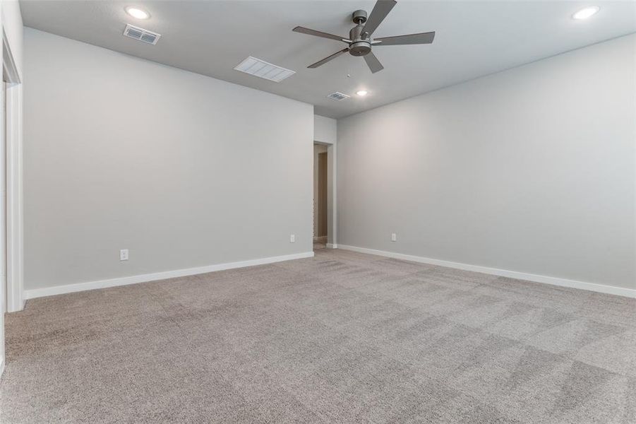 Spare room with carpet floors and ceiling fan