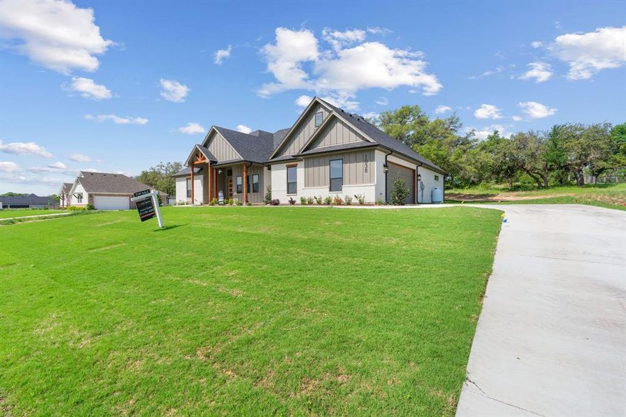 Craftsman-style house featuring a garage and a front lawn