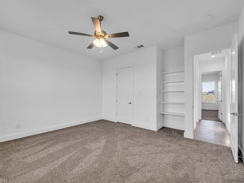 Unfurnished bedroom featuring carpet flooring, a closet, and ceiling fan