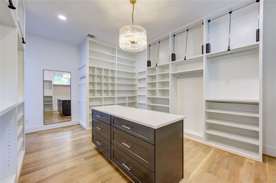 Large Drawers with countertop under the beautiful chandelier. Window to grace the morning sunshine