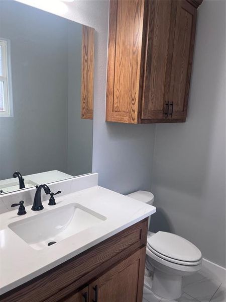 Bathroom featuring vanity and toilet