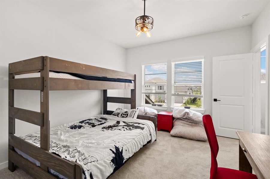 The third bedroom is adorned with plush carpeting and benefits from two windows, providing a cozy and well-lit space.