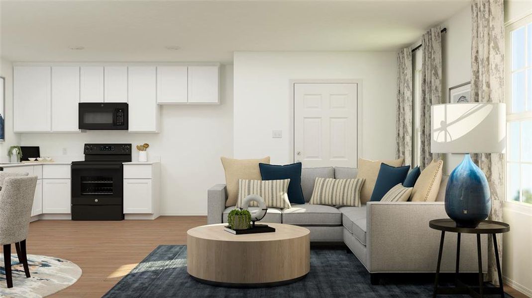 Living room with plenty of natural light and hardwood / wood-style flooring