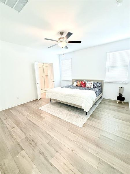 Unfurnished bedroom with light wood-type flooring and ceiling fan