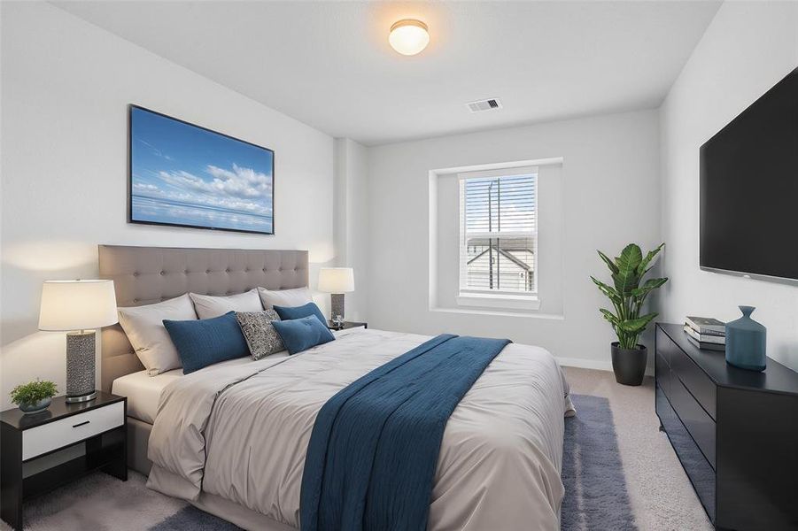 Secondary bedroom features plush carpet, custom neutral paint and a large windows with privacy blinds.