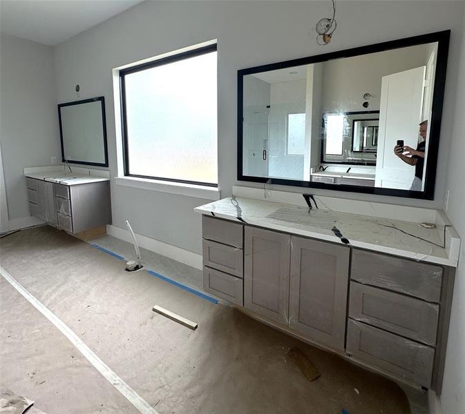 Floating cabinets and framed mirrors are just some of the custom finishes in this bathroom.