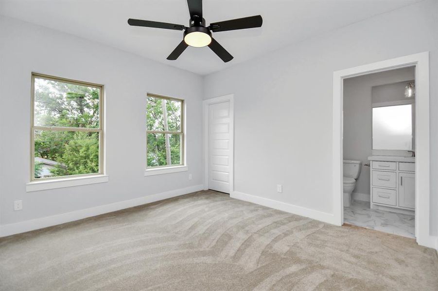 One of two secondary bedrooms upstairs, this one is 12'9"x11'4" and is bathed in natural light! It offers a spacious walk-in closet and direct access to the beautiful secondary full bathroom!