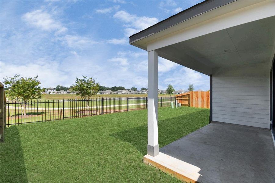 Step into a world of outdoor possibilities with this remarkable backyard and its charming covered patio. From playtime for the kids to relaxation for the adults, this space offers the best of both worlds.