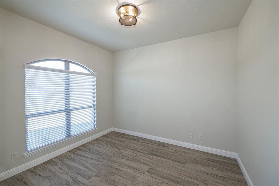 Unfurnished room with hardwood / wood-style floors