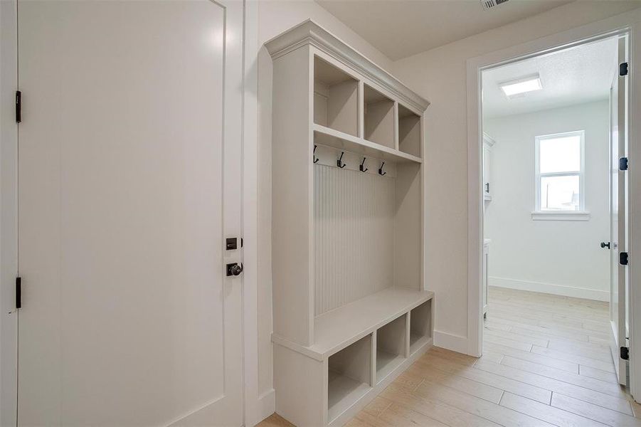 Mudroom with light hardwood / wood-style flooring