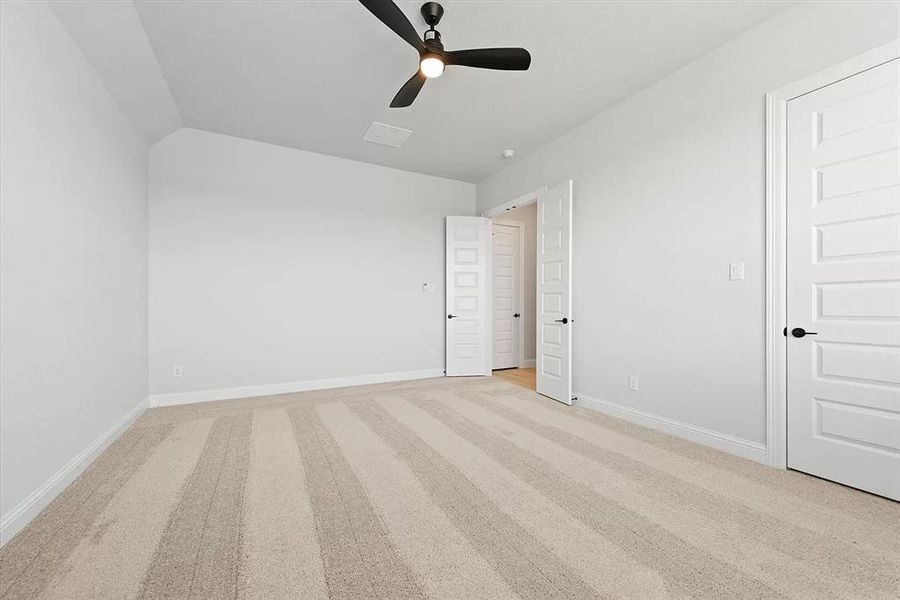 Game room featuring ceiling fan and light colored carpet with a walk-in closet