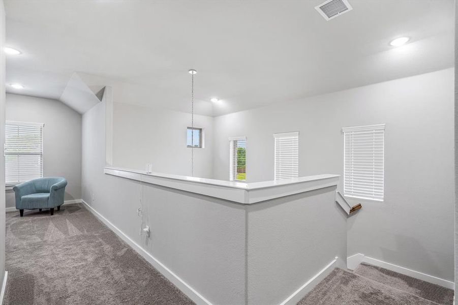 Hallway featuring carpet flooring