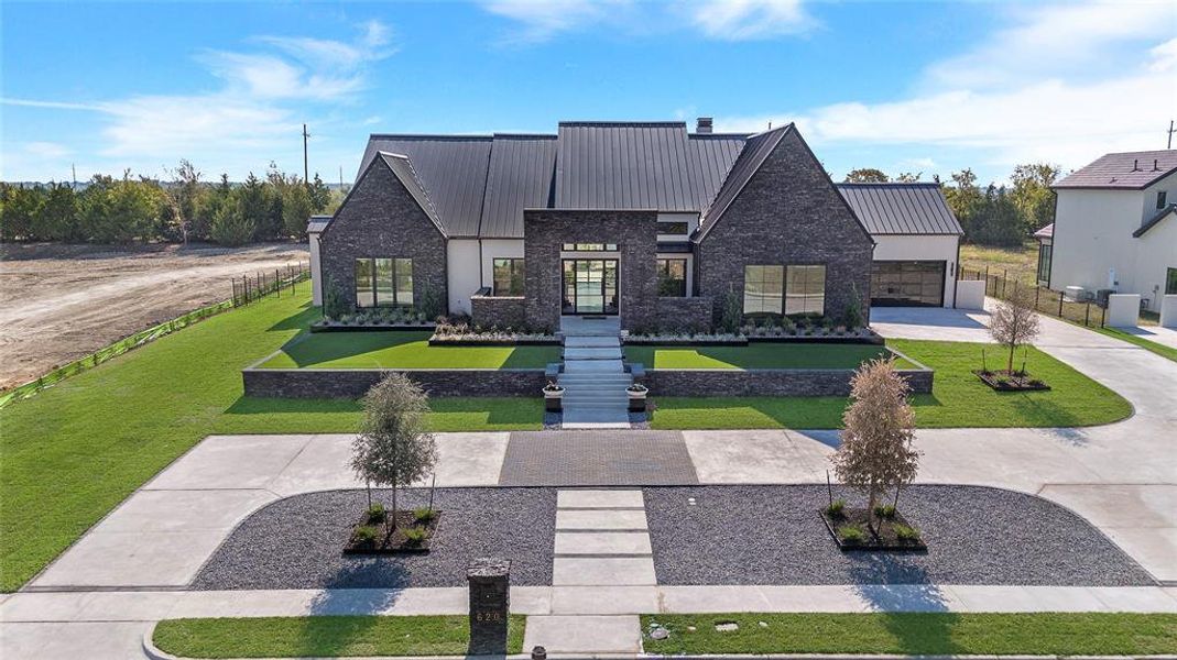 View of front of home featuring a front yard and a garage